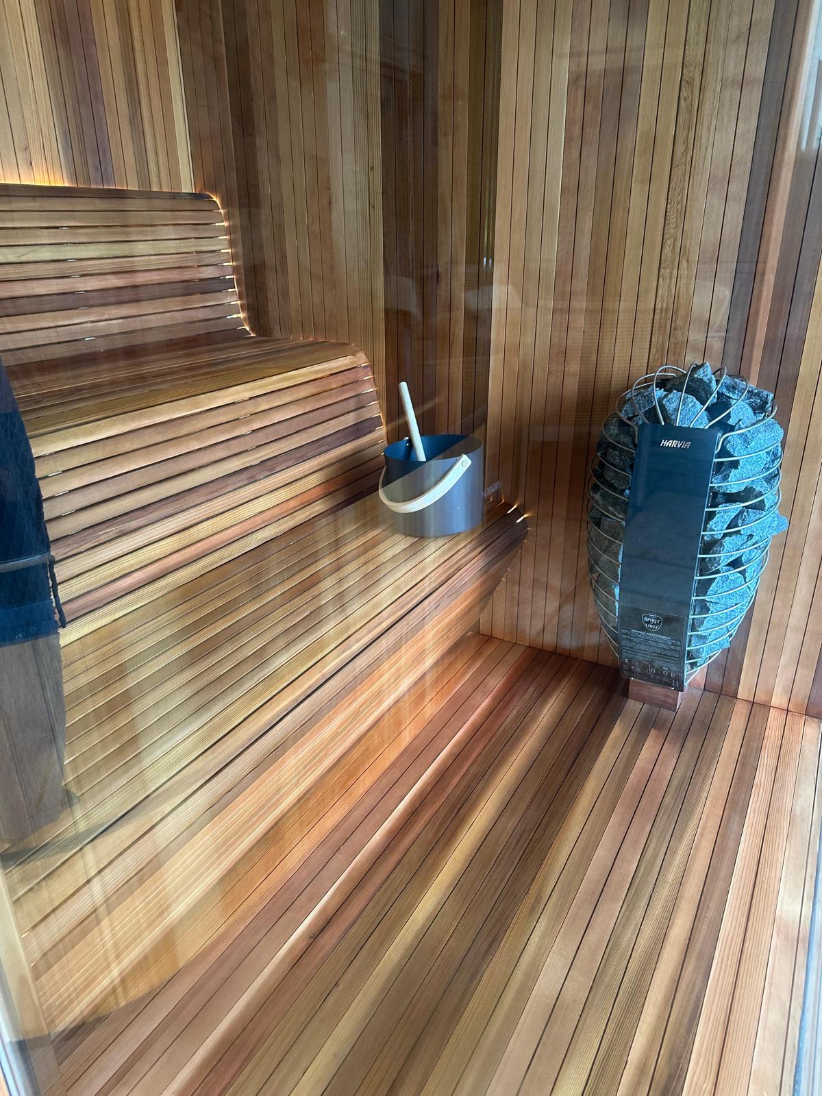 Cedar sauna viewed through tempered glass