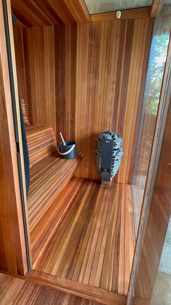 Clear cedar sauna interior with skylight and Harvia heater