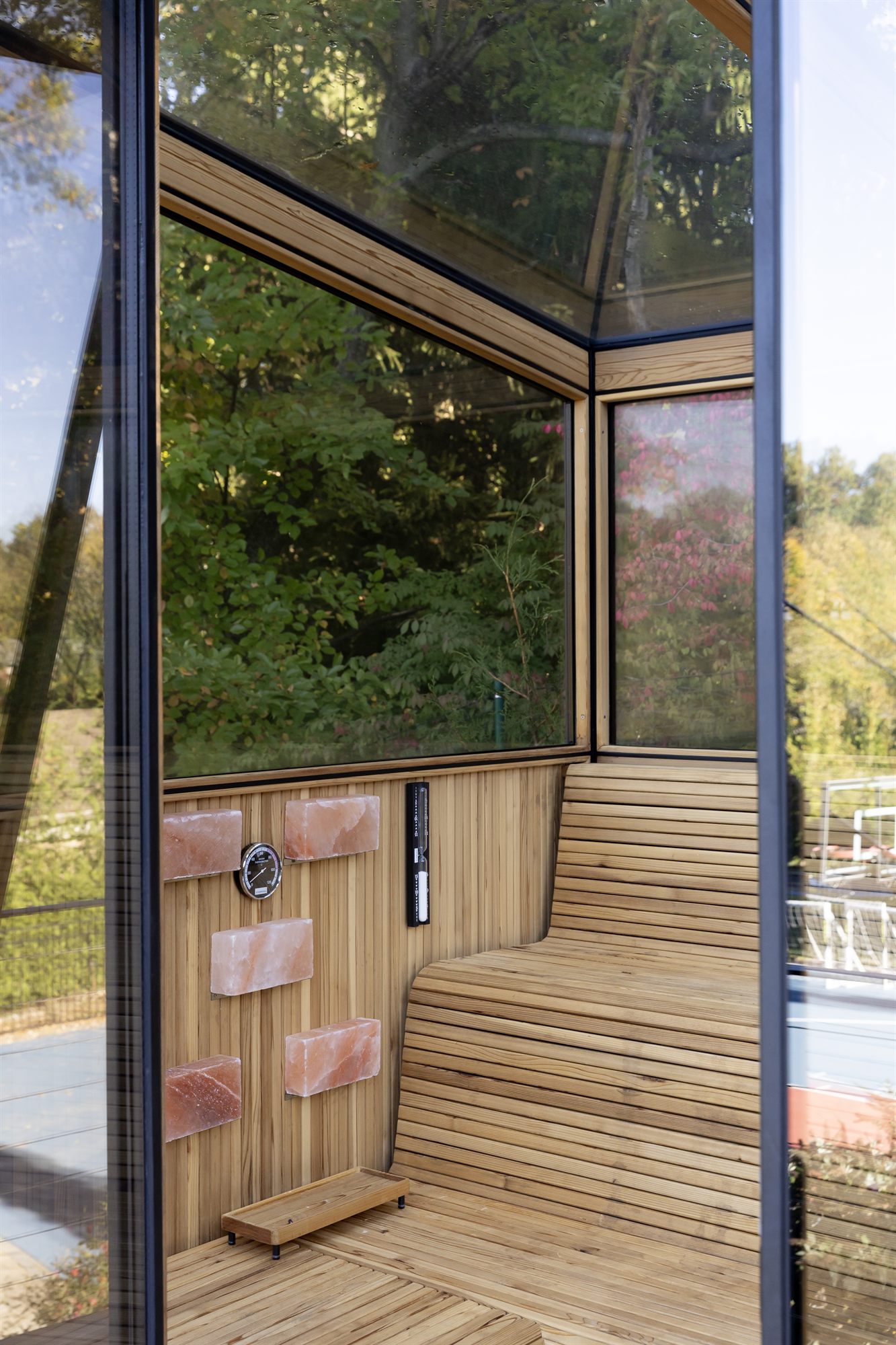 A Cielo glass roof sauna interior, clear cedar benches and insulated glass