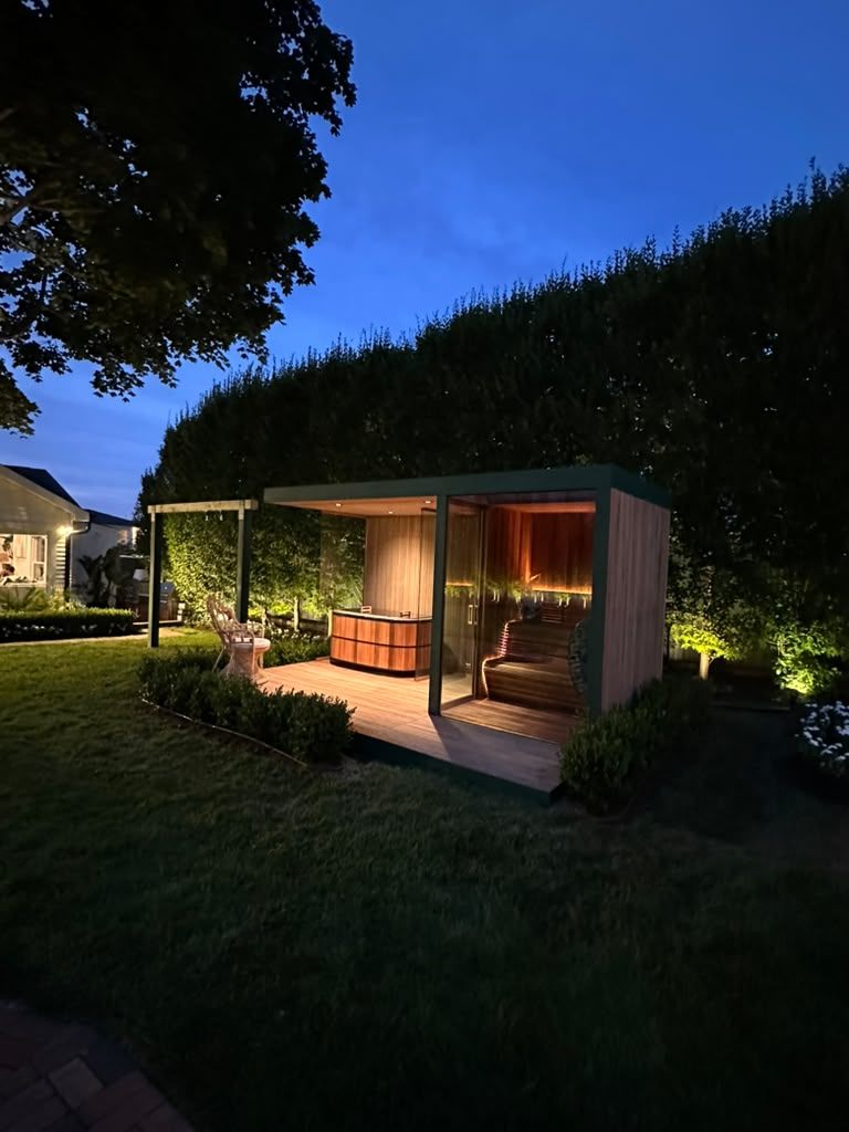 Glass-fronted sauna and cold plunge lit for an evening hosting session