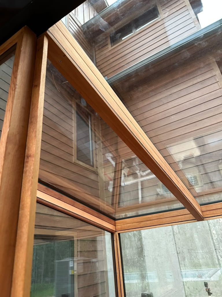 Structural glass and cedar detail on a custom outdoor spa house roofline